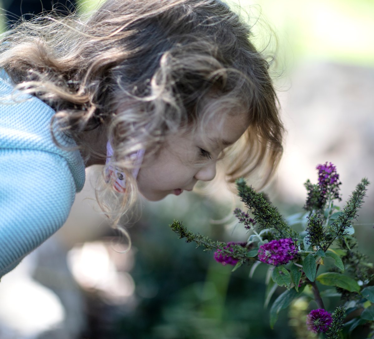 girl smelling flower