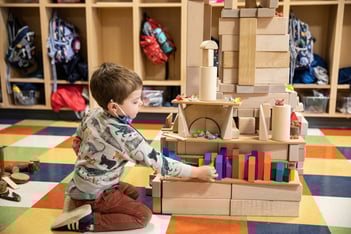 Boy builds structure with blocks