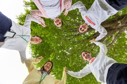 FA girls holding hands in a circle