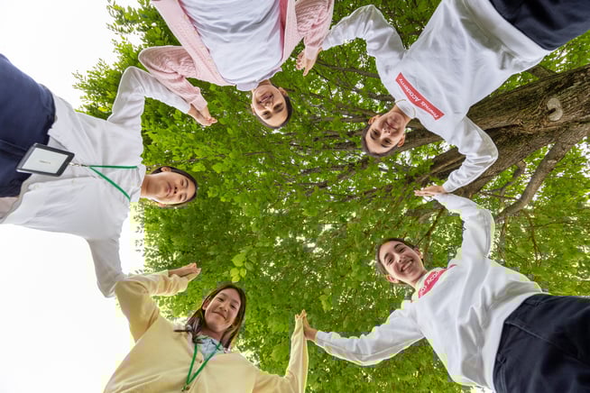 FA girls holding hands in a circle