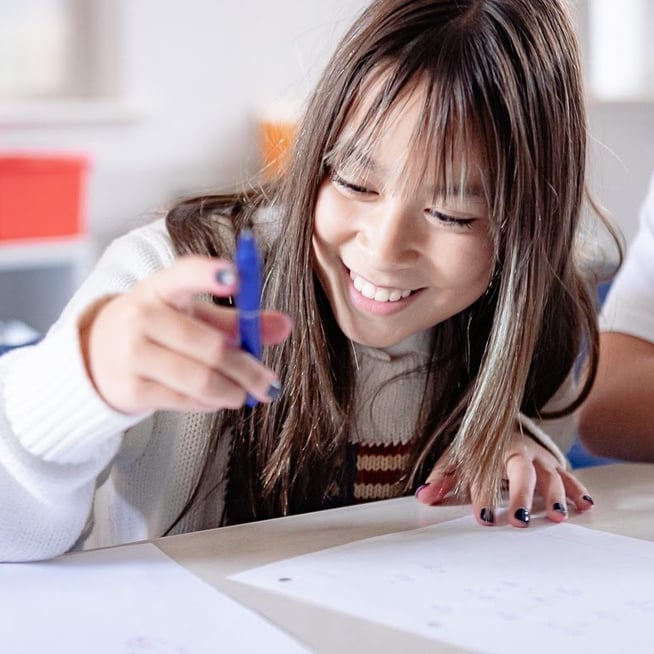 middle school girl holding a pen