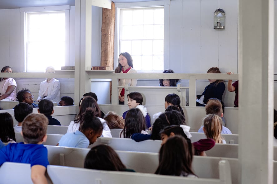 Girl stands to share message at Quaker Meeting for Worship