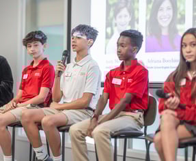 middle school students engaged in public speaking