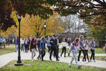 group of friends academy students walking across campus