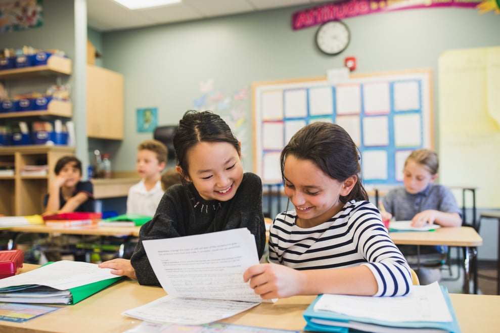 two Friend's Academy students studying a worksheet together win a classroom