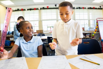 girl and boy with worksheet-1