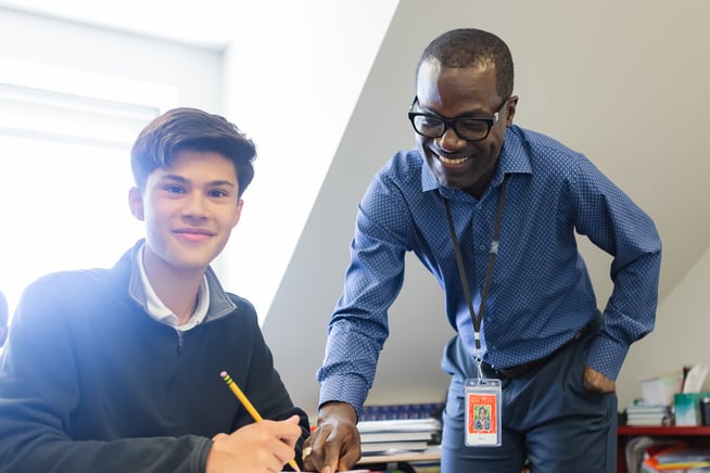 student and teacher at desk