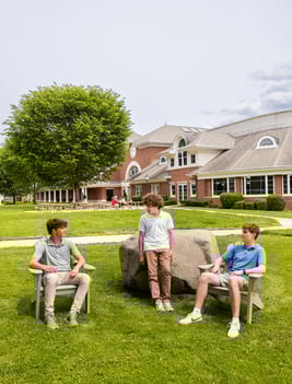 teenage boys sitting in chairs