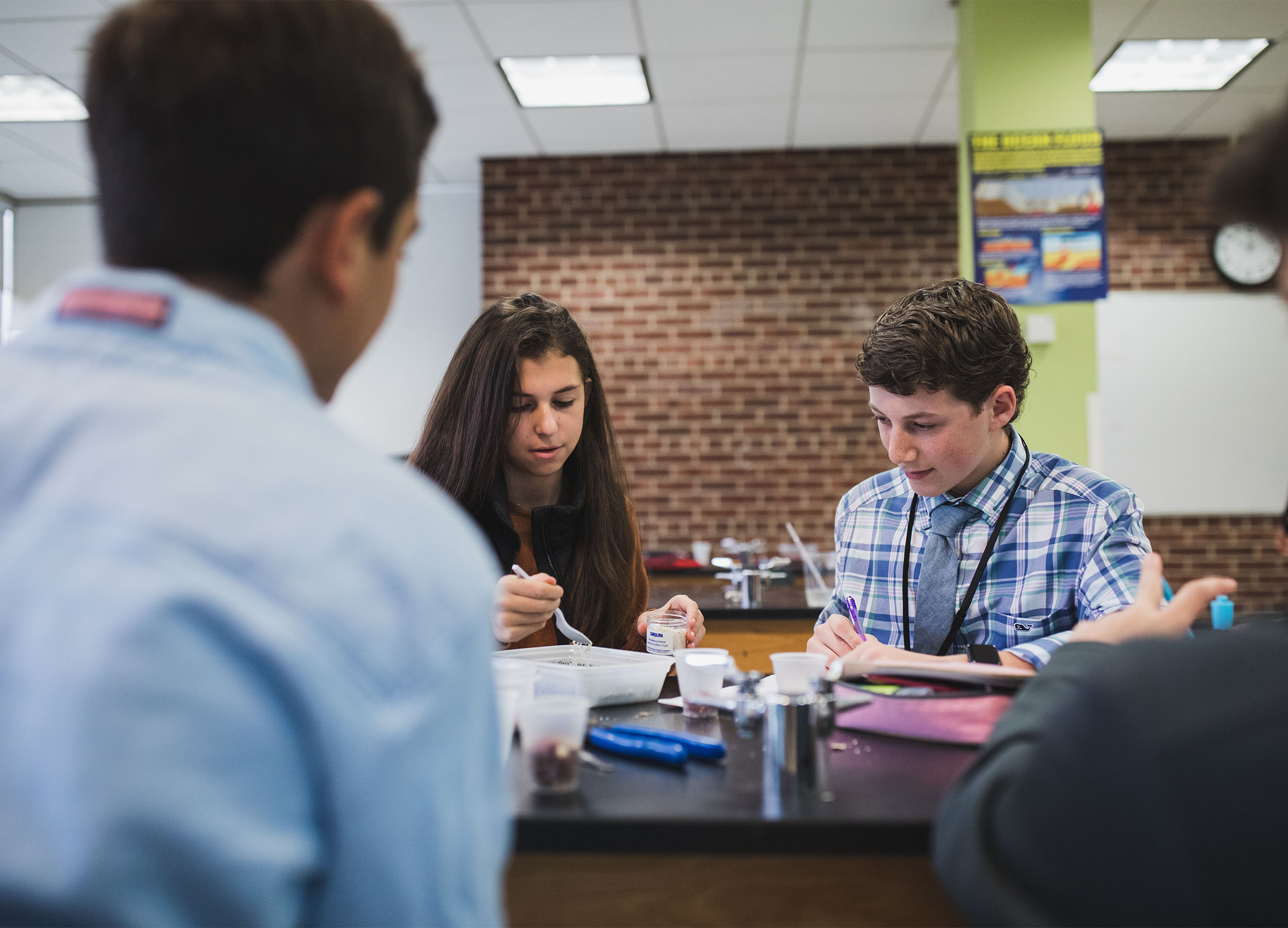 upper school boy and girl in science class