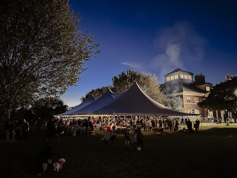Family Night BBQ under a tent at night