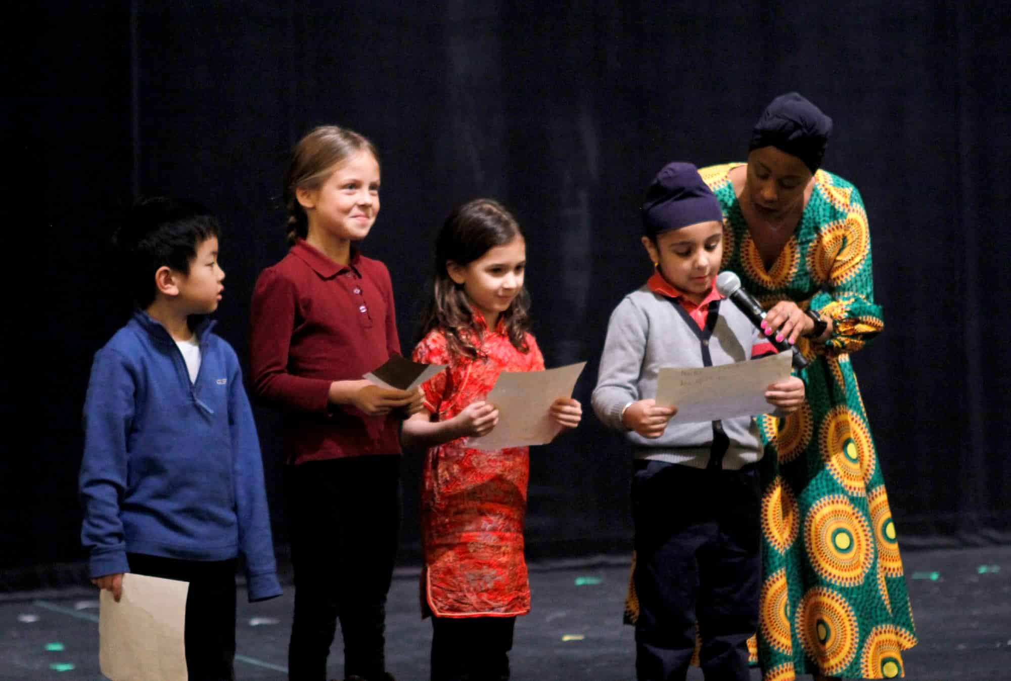 Four students on stage with Camille Edwards