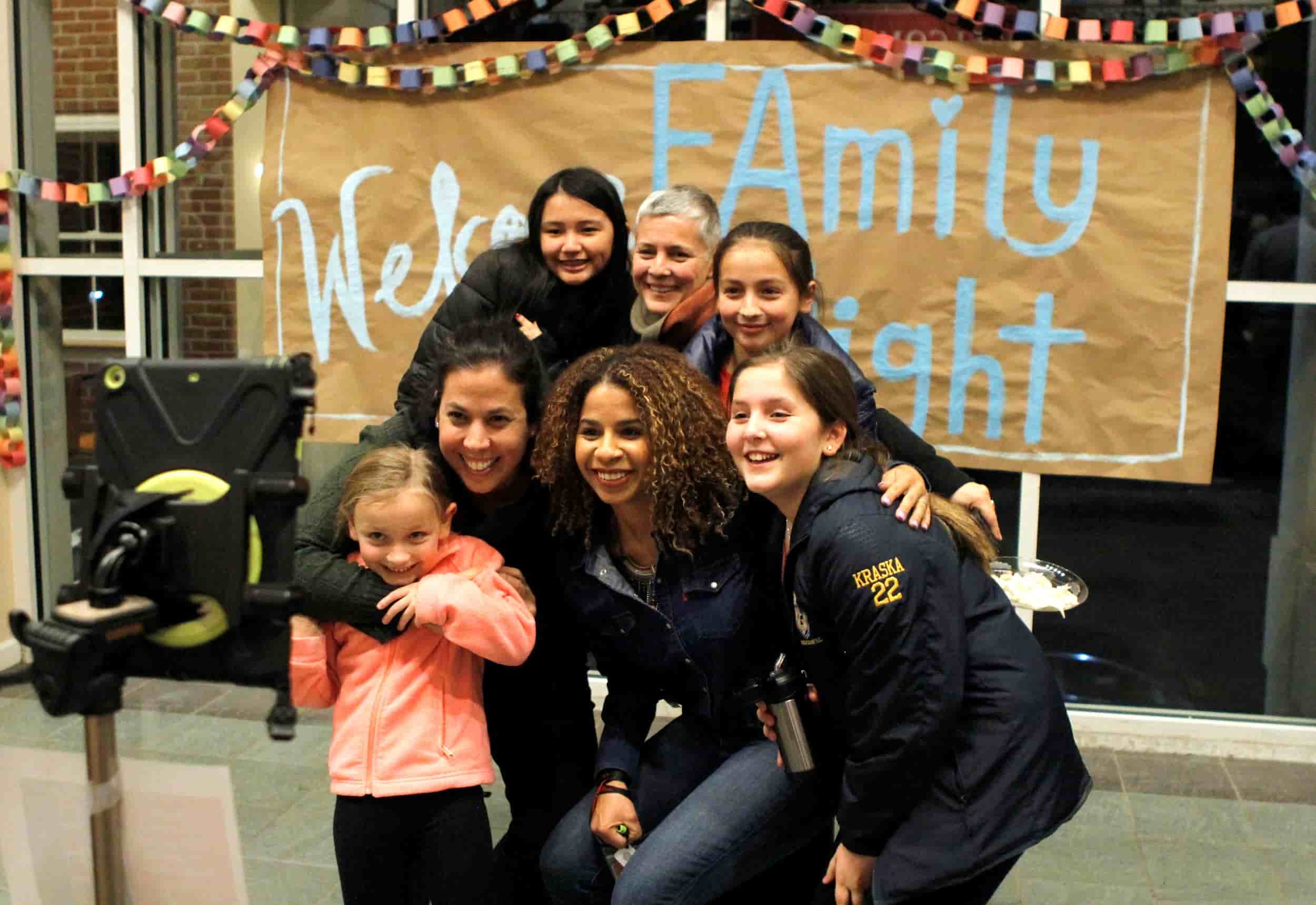 Adults and children posing for a photo at FAmily Night