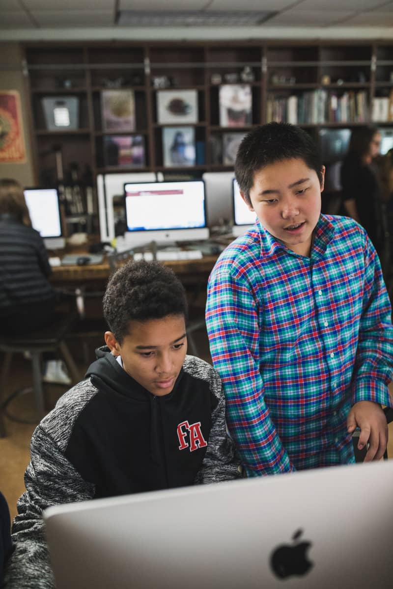 middle-school-students-looking-at-computer