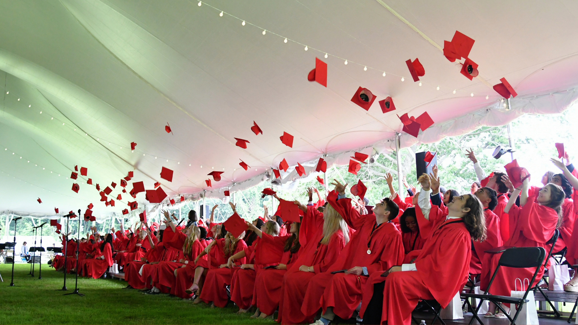 friends academy graduates throwing their caps